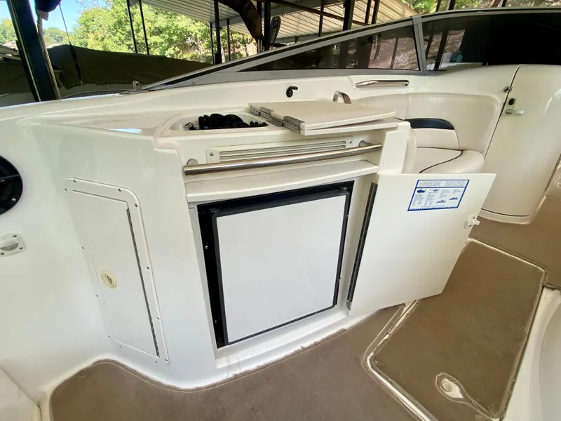 Slide: The Image of 2000 Chaparral 280 SSi boat interior with open cabinet and mini fridge. - 31