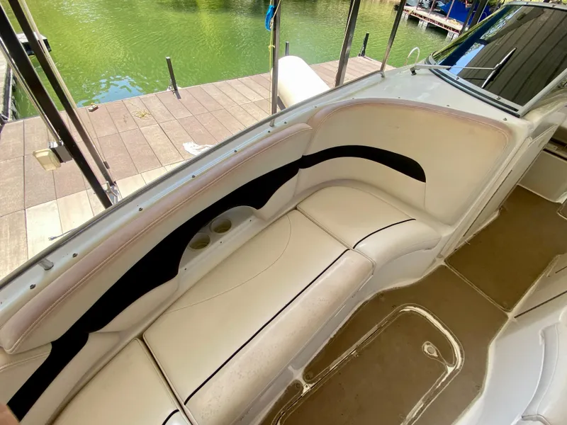Slide: The Image of 2000 Chaparral 280 SSi boat interior with white seating and cup holders. - 33