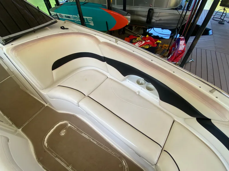 Slide: The Image of 2000 Chaparral 280 SSi boat interior with white seating and cup holders. - 34