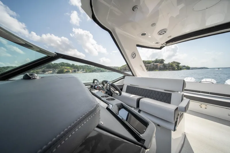 Slide: The Image of 2024 Monterey 385SS boat interior with luxurious seating and scenic water view. - 31
