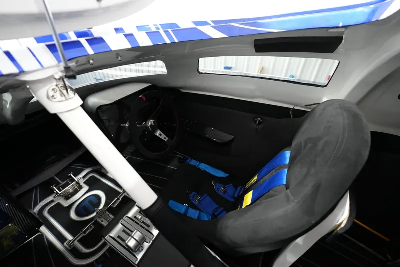 Slide: The Image of Interior of a 2007 Mystic Powerboats 50' with racing seat and steering wheel. - 10