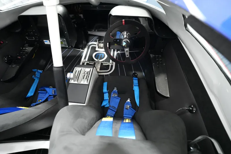 Slide: The Image of Interior of a 2007 Mystic Powerboats 50' with racing seats and steering wheel. - 11