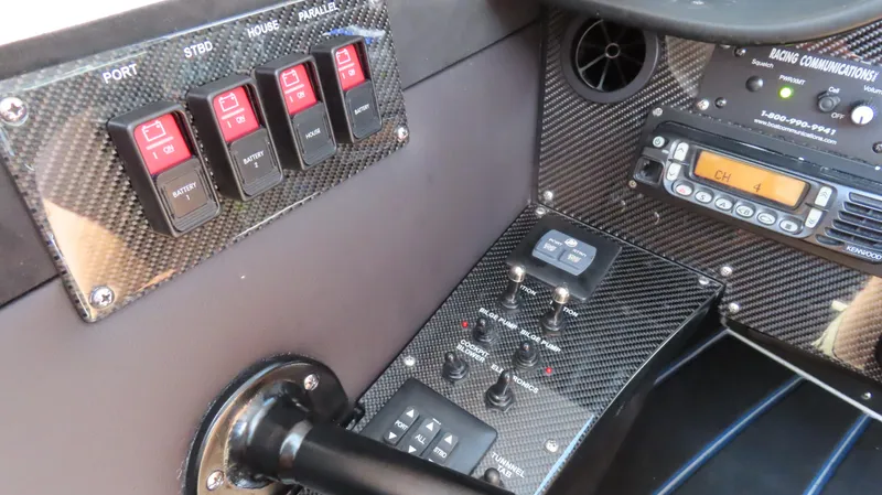 Slide: The Image of Control panel of a 2007 Mystic Powerboats 50' with carbon fiber finish. - 13