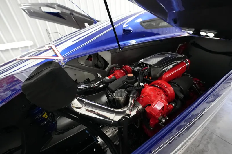 Slide: The Image of Engine compartment of a 2007 Mystic Powerboats 50' with red and chrome components. - 14