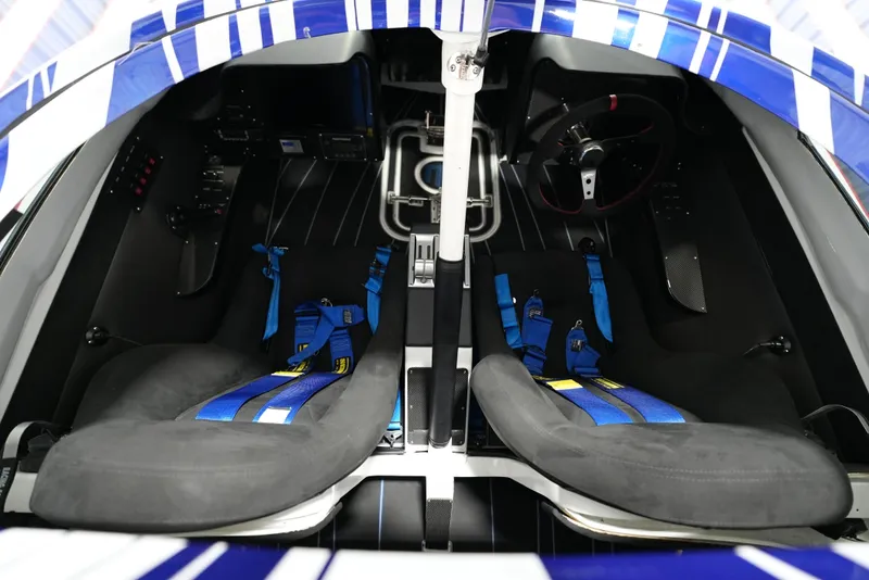 Slide: The Image of Interior of a 2007 Mystic Powerboats 50' with dual seats and blue harnesses. - 17