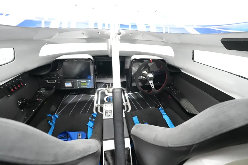 Slide: The Image of Interior of a 2007 Mystic Powerboats 50' cockpit with modern controls and seating. - 18