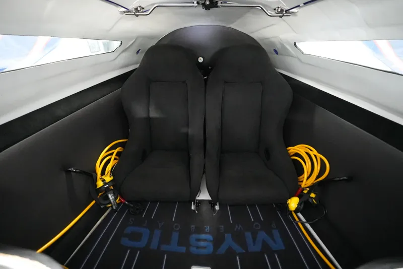 Slide: The Image of Interior of 2007 Mystic Powerboats 50' with two black seats and safety equipment. - 22