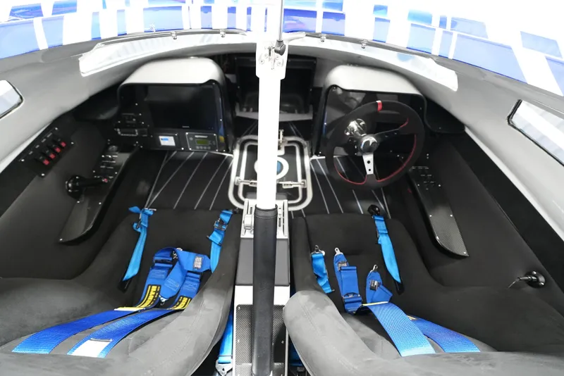 Slide: The Image of Interior of a 2007 Mystic Powerboats 50' with dual seats and blue harnesses. - 23