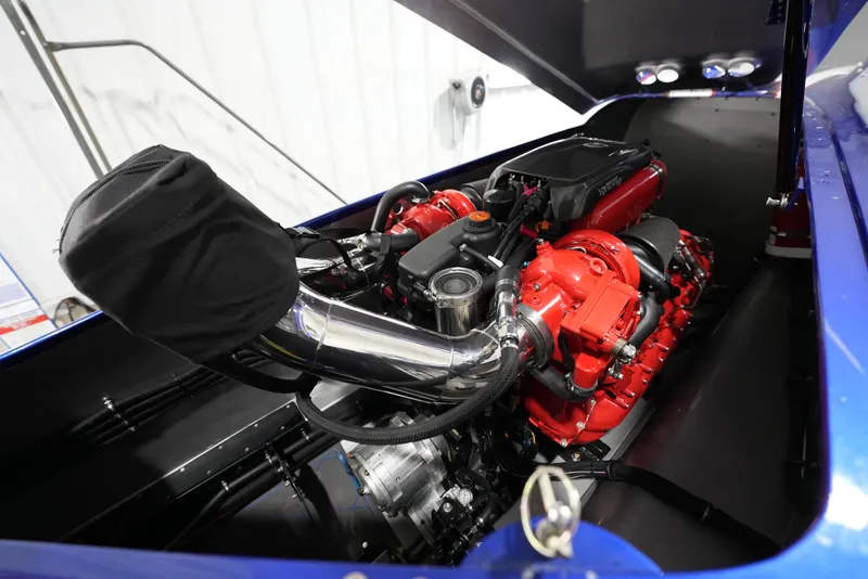 Slide: The Image of Engine of 2007 Mystic Powerboats 50', featuring red components and chrome detailing. - 24