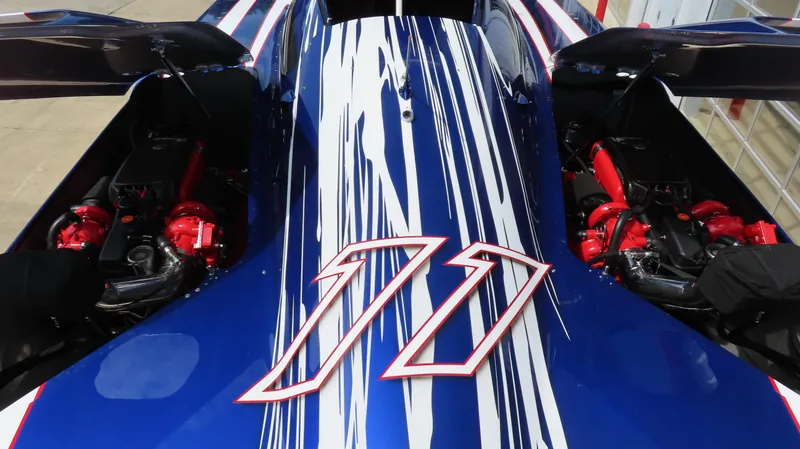 Slide: The Image of 2007 Mystic Powerboats 50' with striking blue and white design, showcasing powerful engines. - 28