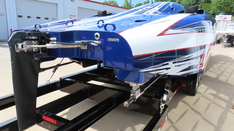 Slide: The Image of 2007 Mystic Powerboats 50' on trailer, showcasing sleek blue and white design. - 3