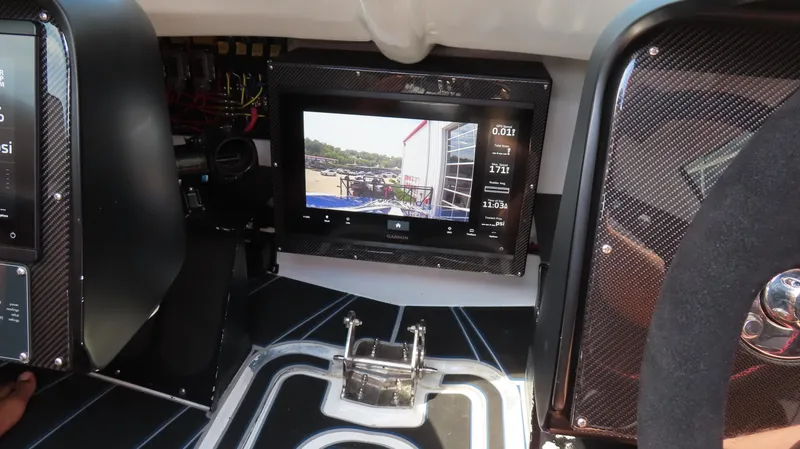 Slide: The Image of Control panel of a 2007 Mystic Powerboats 50' with digital display and carbon fiber accents. - 31