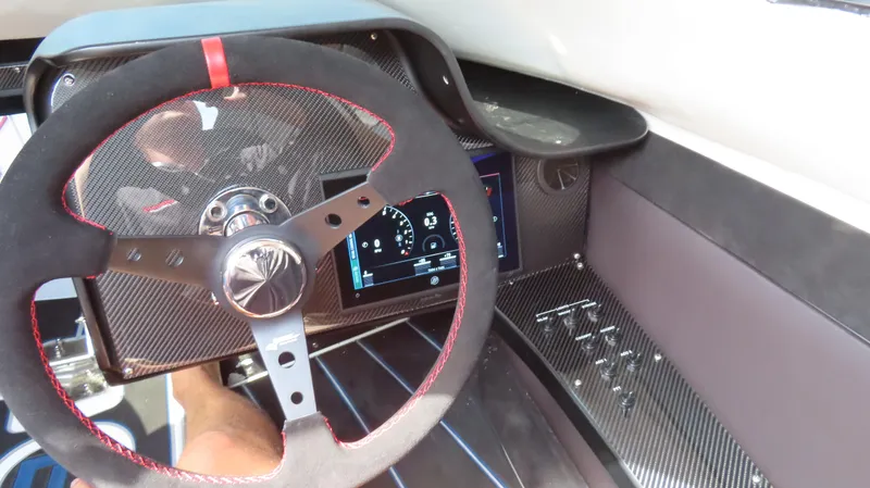 Slide: The Image of Interior cockpit of a 2007 Mystic Powerboats 50' with carbon fiber steering wheel. - 32