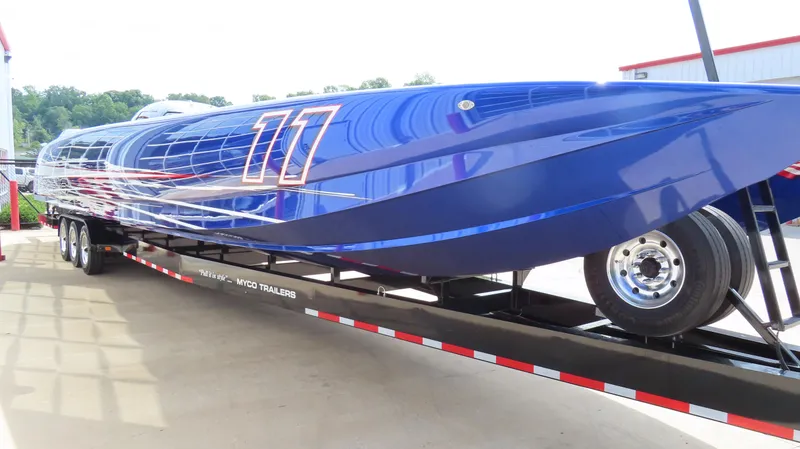 Slide: The Image of 2007 Mystic Powerboats 50' in blue on trailer, sleek design, vibrant graphics. - 4