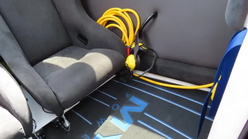 Slide: The Image of Interior of 2007 Mystic Powerboats 50' with seat and coiled yellow hose. - 7