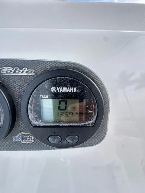 Slide: The Image of Yamaha tachometer on a 2005 Cobia 214 CC boat dashboard. - 16