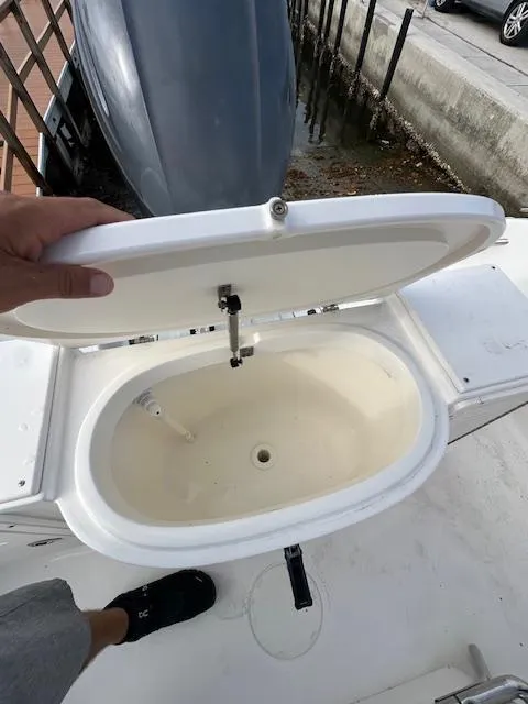 Slide: The Image of 2005 Cobia 214 CC boat livewell with open lid, showing interior. - 17