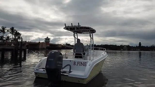 Slide: The Image of 2005 Cobia 214 CC boat on water under cloudy sky. - 8