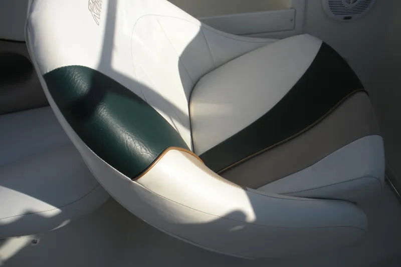 Slide: The Image of White and green seat in 1999 Rinker 232 Captiva Cuddy boat interior. - 15