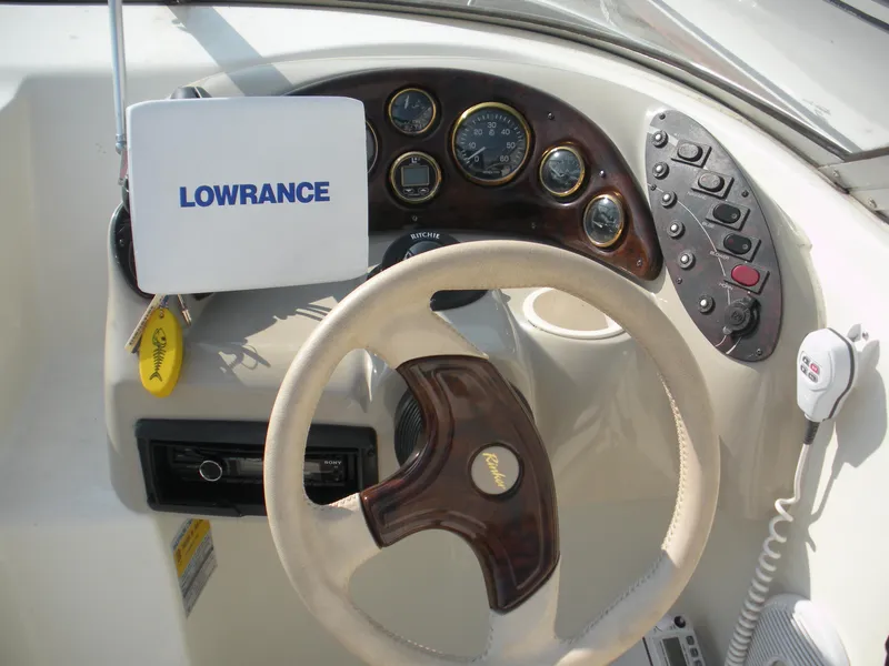 Slide: The Image of 1999 Rinker 232 Captiva Cuddy boat on trailer at Happy Days Boating Co. - 2