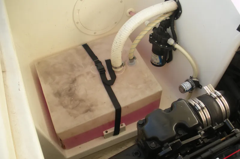 Slide: The Image of 1999 Rinker 232 Captiva Cuddy engine compartment with fuel tank and hoses. - 20