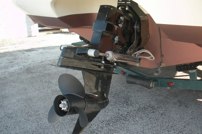 Slide: The Image of 1999 Rinker 232 Captiva Cuddy boat propeller and stern drive on trailer. - 23