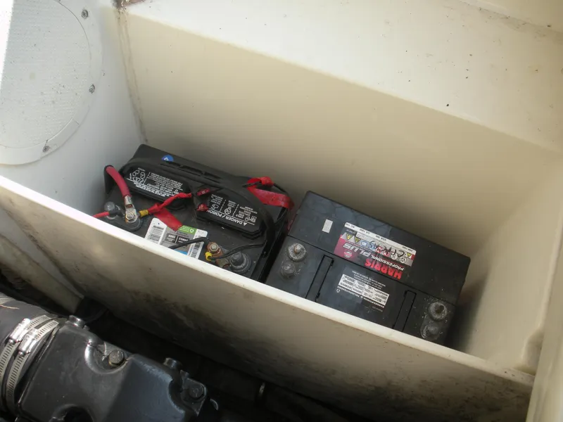 Slide: The Image of 1999 Rinker 232 Captiva Cuddy interior with cushioned seating and carpeted flooring. - 8