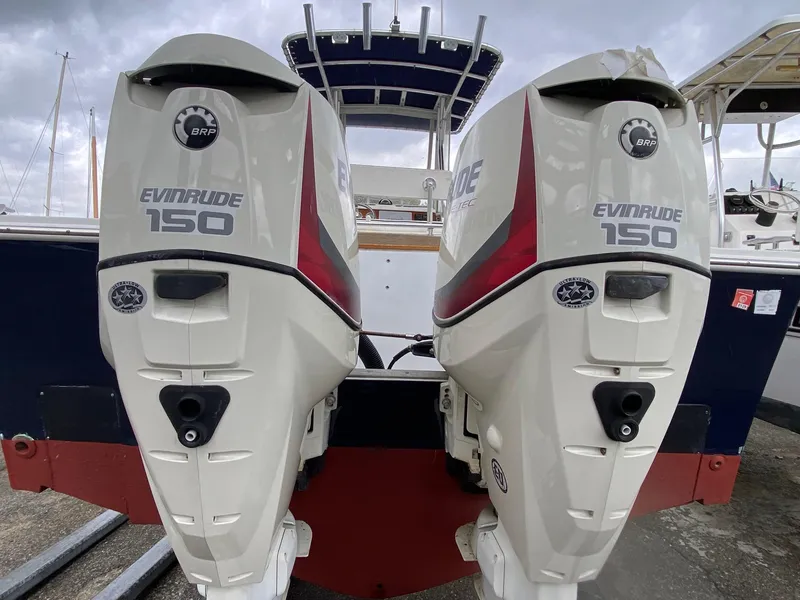 Slide: The Image of Twin Evinrude 150 outboard motors on a 1991 Mako 241 boat. - 11