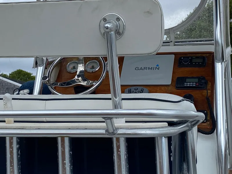 Slide: The Image of 1991 Mako 241 boat dashboard with Garmin navigation system and steering wheel. - 16