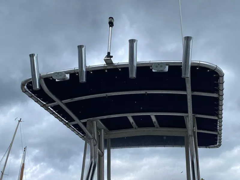 Slide: The Image of T-top of a 1991 Mako 241 boat against a cloudy sky. - 18