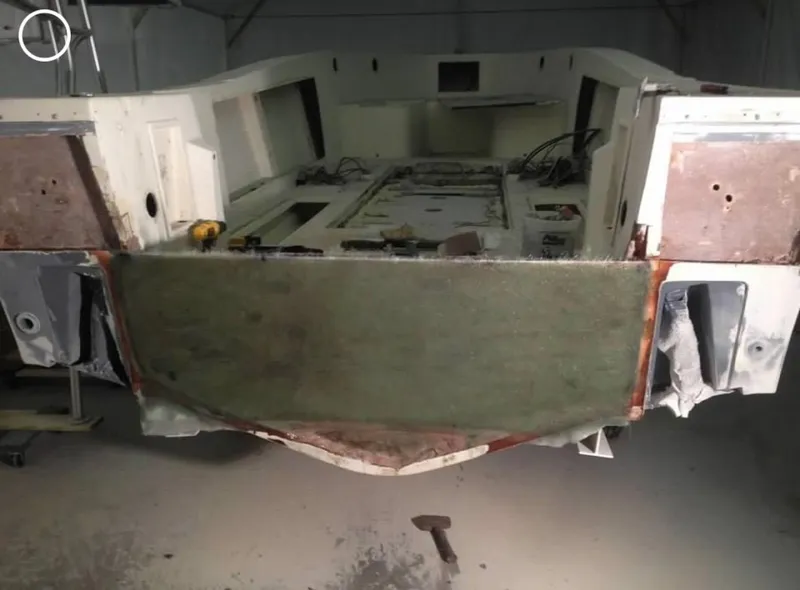 Slide: The Image of 1991 Mako 241 boat hull under restoration in a workshop. - 20