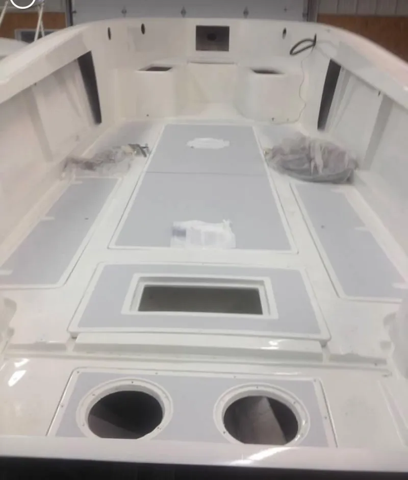 Slide: The Image of 1991 Mako 241 boat interior, featuring spacious deck and storage compartments. - 22