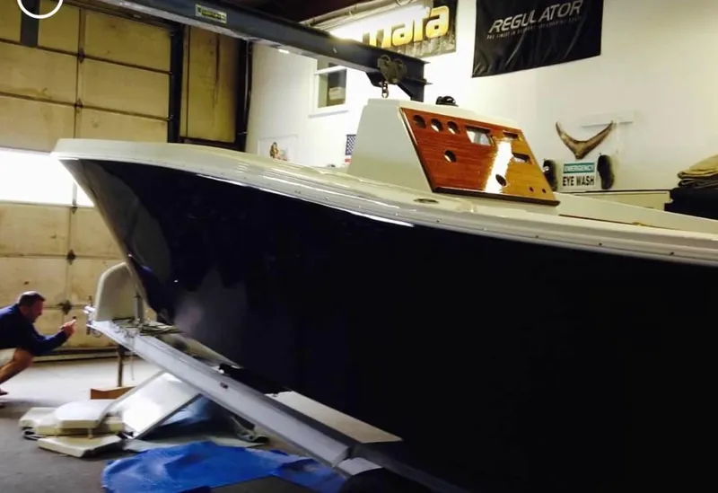 Slide: The Image of 1991 Mako 241 boat in a garage, undergoing maintenance or restoration. - 25