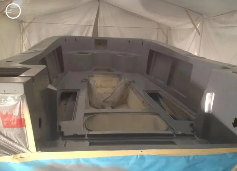 Slide: The Image of 1991 Mako 241 boat hull under construction in a workshop. - 26