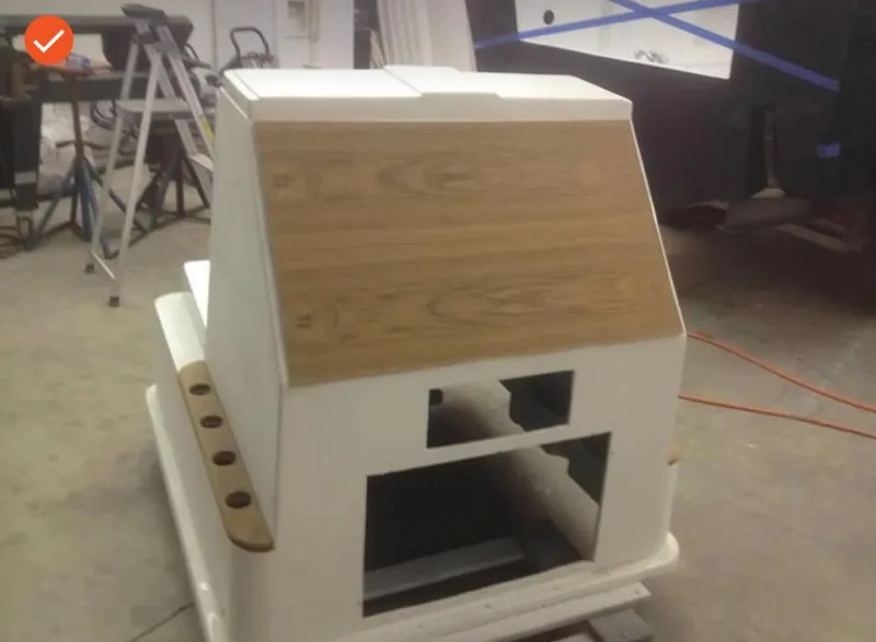 Slide: The Image of 1991 Mako 241 boat console with wood paneling in a workshop setting. - 27