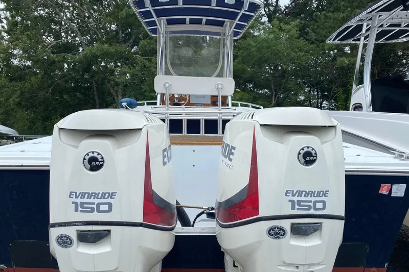Slide: The Image of 1991 Mako 241 boat with dual Evinrude 150 outboard motors, rear view. - 34
