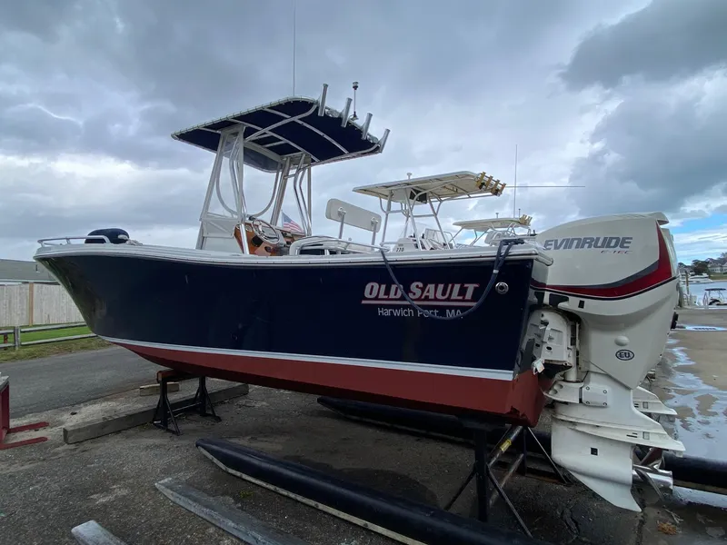 Slide: The Image of 1991 Mako 241 boat with Evinrude engine, docked under cloudy skies. - 5