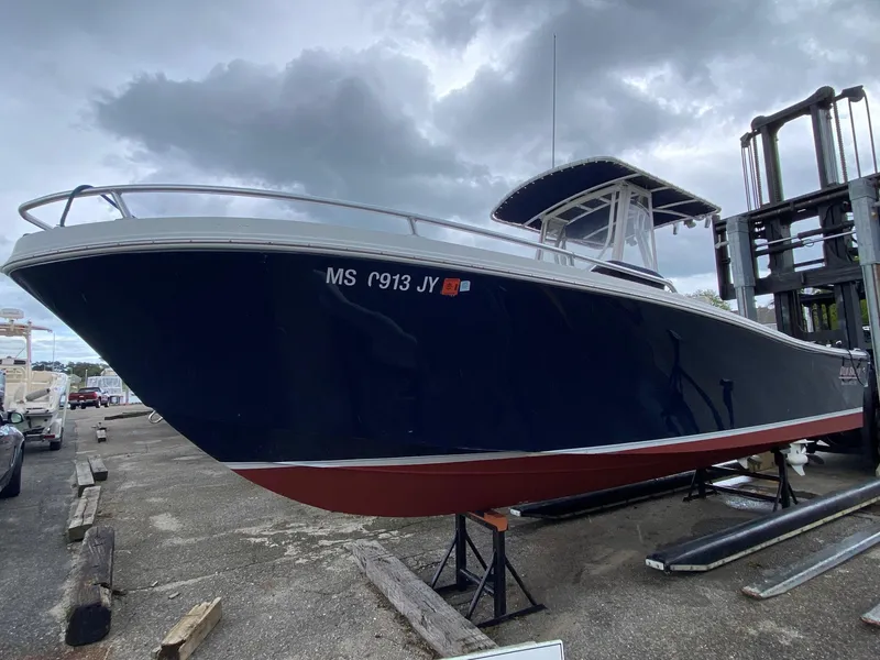 Slide: The Image of 1991 Mako 241 boat on dry dock under cloudy sky. - 8