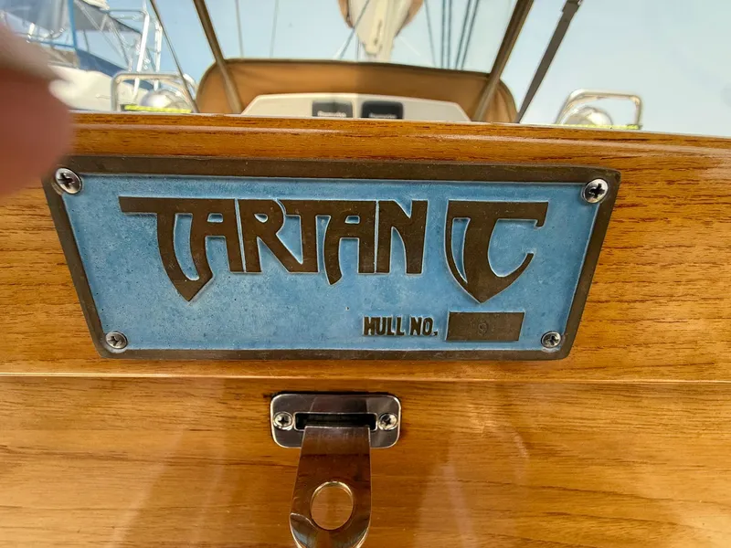 Slide: The Image of Tartan 4000 sailboat nameplate, 2012 model, featuring hull number on wooden surface. - 14