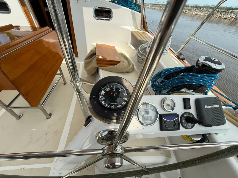 Slide: The Image of Cockpit of 2012 Tartan 4000 sailboat with compass, navigation instruments, and ropes. - 24