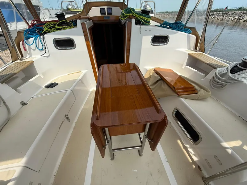 Slide: The Image of 2012 Tartan 4000 yacht cockpit with wooden table, ropes, and seating. - 28