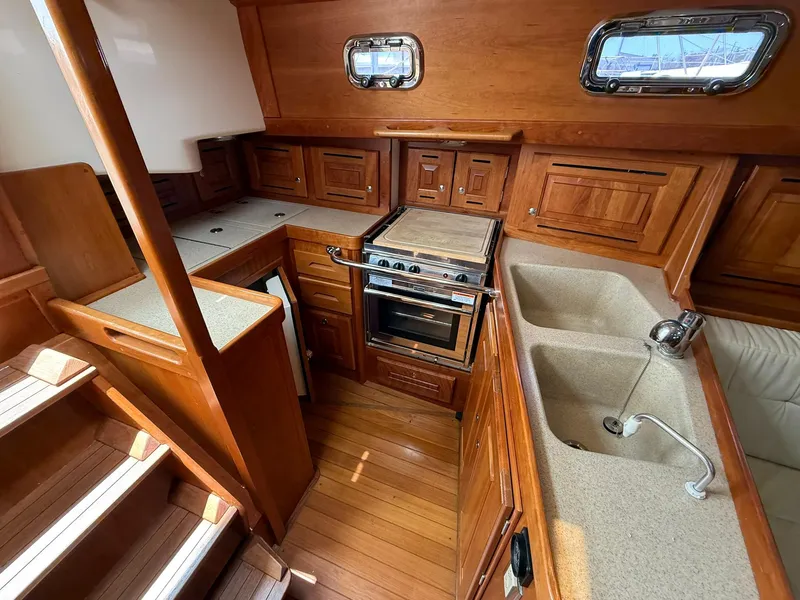 Slide: The Image of Interior of 2012 Tartan 4000 yacht kitchen with wood cabinetry and dual sinks. - 38