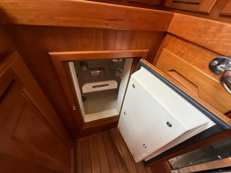 Slide: The Image of Wooden interior of a 2012 Tartan 4000 yacht, featuring a small storage compartment. - 42