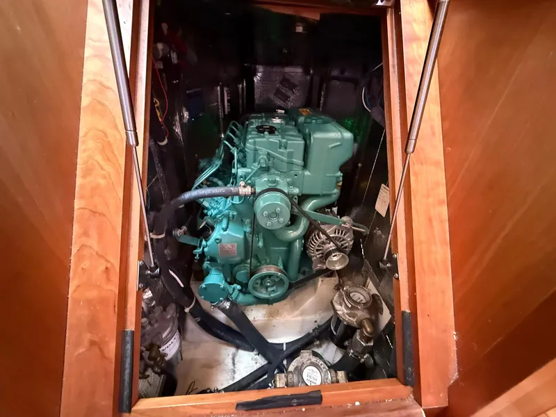 Slide: The Image of Engine compartment of a 2012 Tartan 4000 sailboat, showcasing a green marine engine. - 44