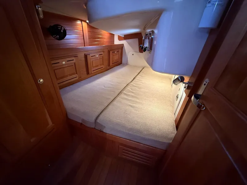 Slide: The Image of Cozy cabin interior of 2012 Tartan 4000 yacht with wooden finish and comfortable bedding. - 46