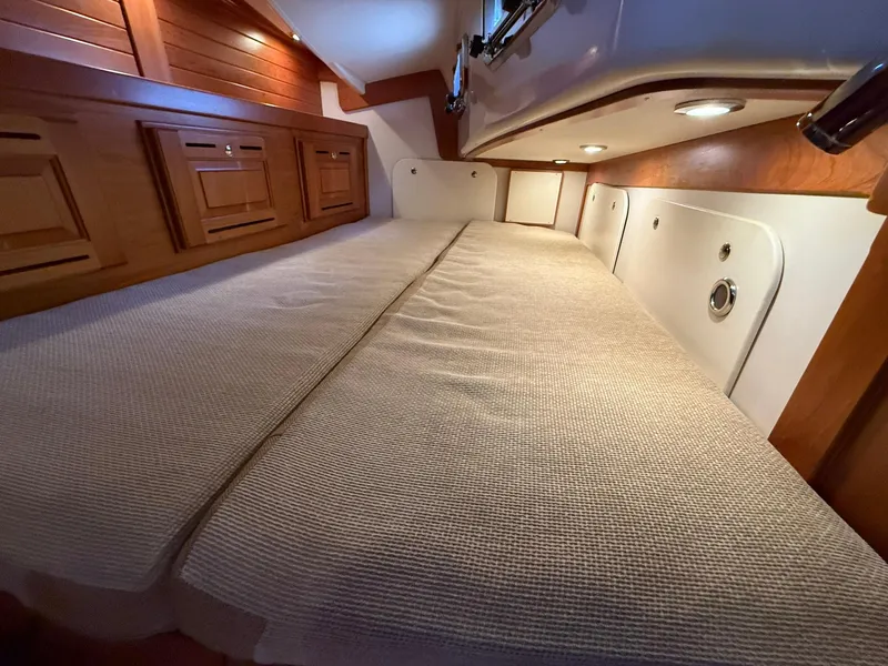 Slide: The Image of Luxurious cabin interior of 2012 Tartan 4000 yacht with cozy bedding and wooden accents. - 47