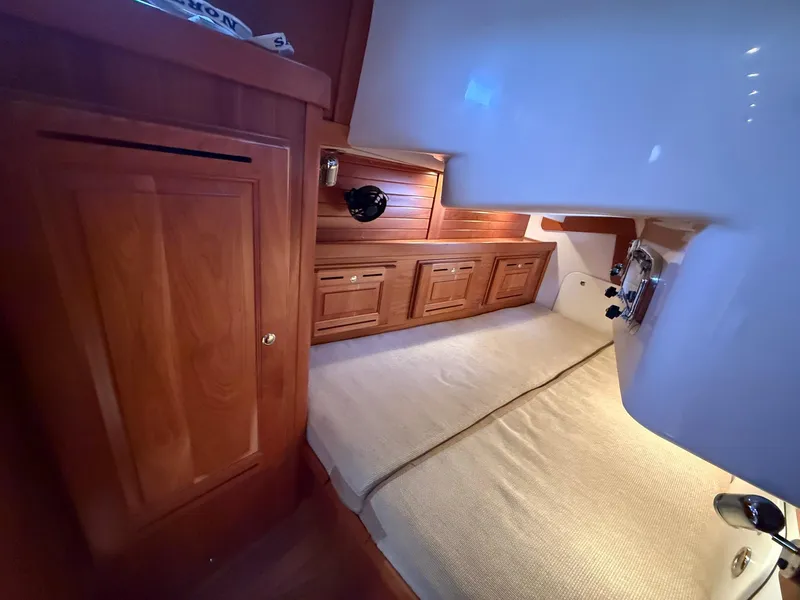 Slide: The Image of Cozy cabin interior of 2012 Tartan 4000 yacht with wooden cabinetry and comfortable bedding. - 48