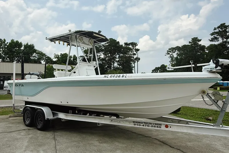 Slide: The Image of 2005 Sea Fox 245 Bay Fisher boat on trailer, parked outdoors under cloudy sky. - 3