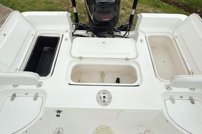 Slide: The Image of 2005 Sea Fox 245 Bay Fisher boat deck with storage compartments and outboard motor. - 7