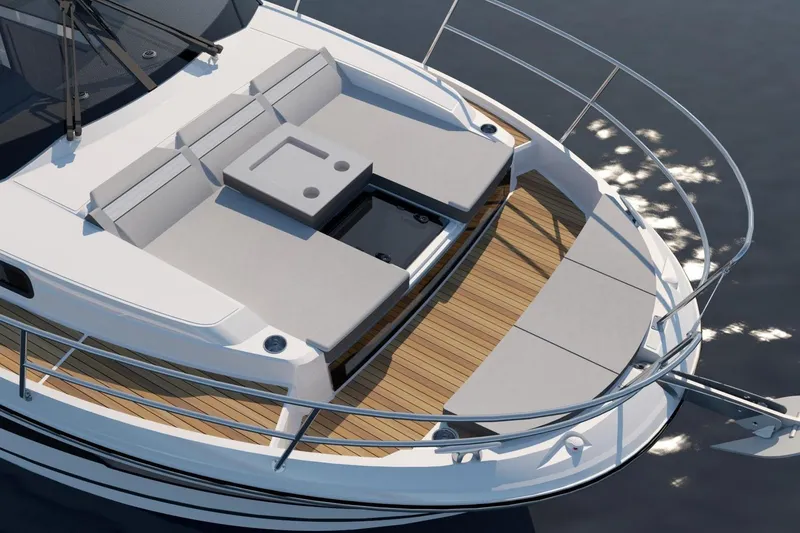 Slide: The Image of 2026 Jeanneau NC 1095 S2 boat with spacious deck and seating area on calm water. - 3
